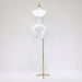 White mannequin torso on a gold stand against a white background