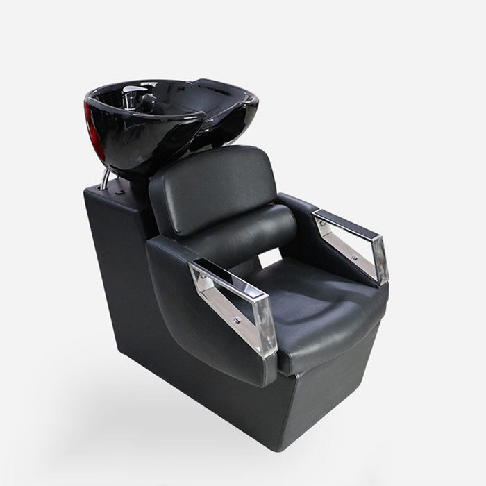 Black salon shampoo chair with bowl on a white background