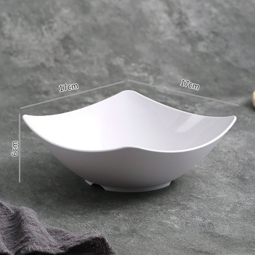 White ceramic bowl with measurements on a gray background
