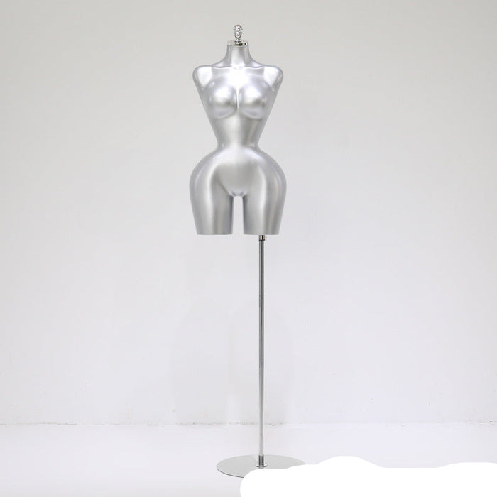Silver mannequin torso on a stand against a white background