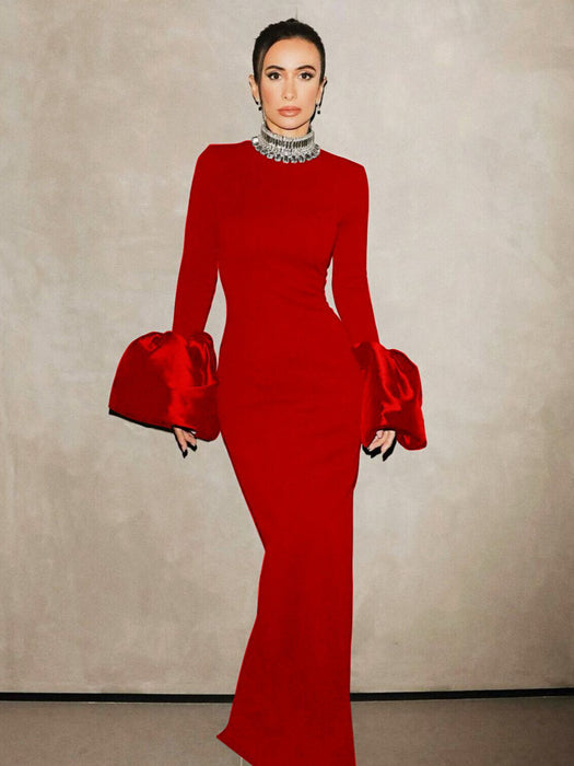 A woman wearing a red long-sleeve dress with a round neckline and a high waist, featuring a solid color with a zipper at the placket.