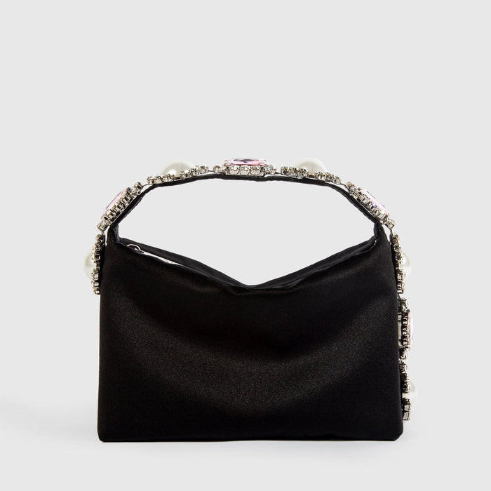 Black handbag with decorative handle on a light gray background