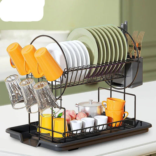 Dish drying rack with plates, cups, and glasses on a white surface.