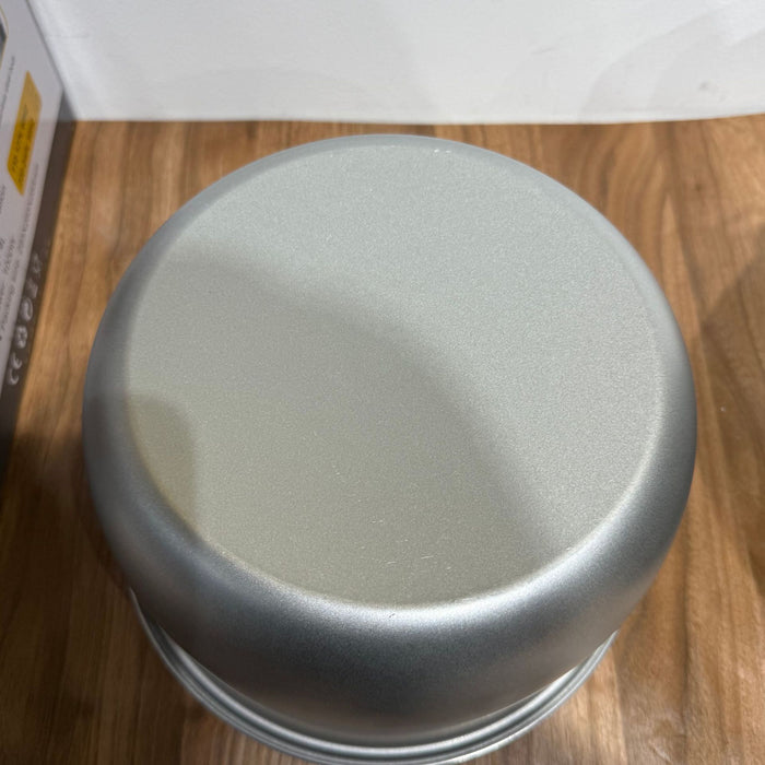 Silver lid on a wooden surface