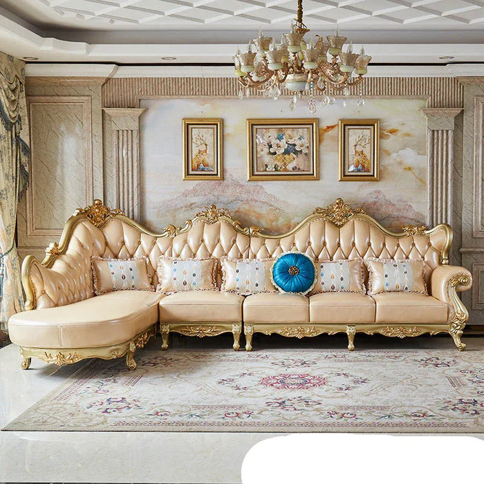 Luxurious living room with ornate beige sofa, decorative pillows, and framed artwork.