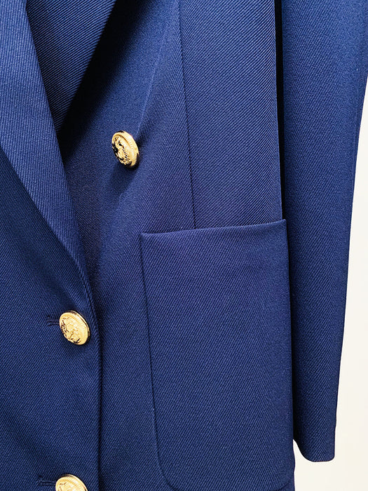 Close-up of a blue blazer with gold buttons on a white background