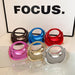 Set of colorful handbags on a white surface with 'FOCUS.' text in the background.