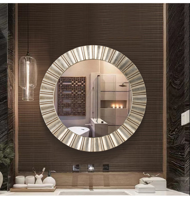 Modern bathroom with a large round mirror and decorative elements.