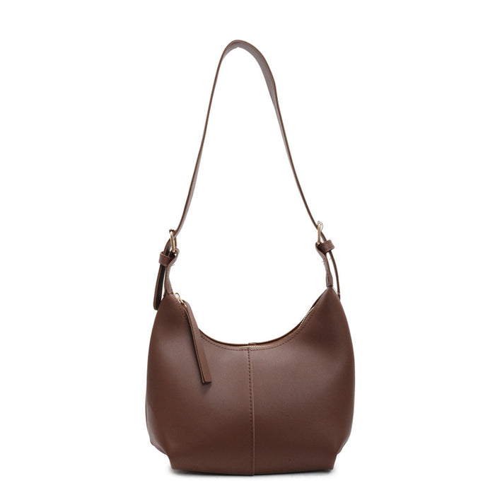 A brown leather shoulder bag with a crescent-shaped body, a single adjustable strap, and a small hanging leather tag, shown against a plain white background.