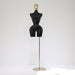 Black mannequin torso on a gold stand against a white background