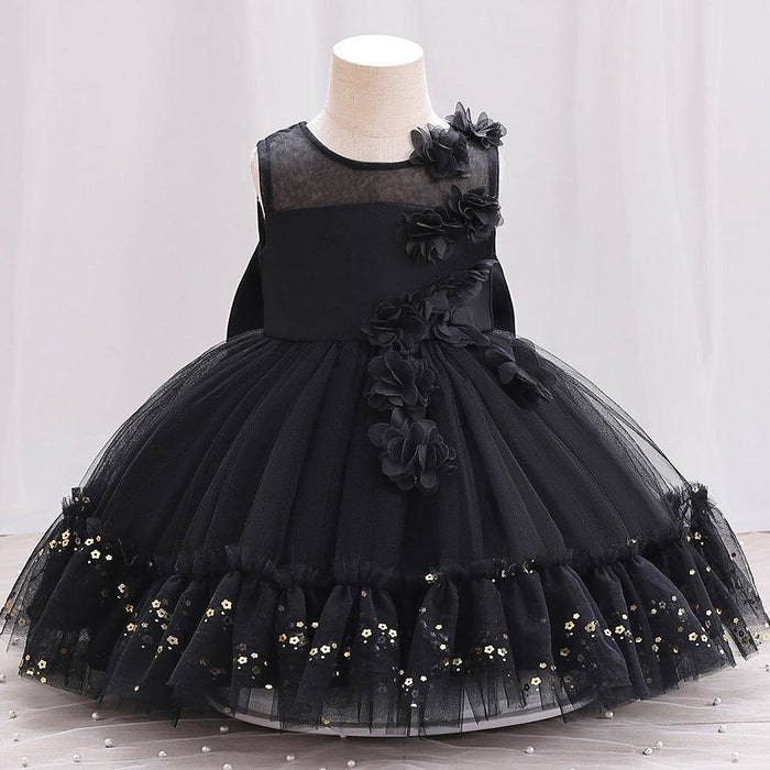 Black flower girl dress on a mannequin against a plain background