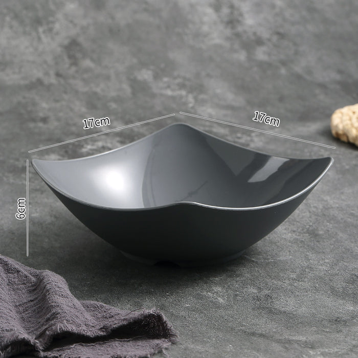 Black ceramic bowl with measurements on a gray surface