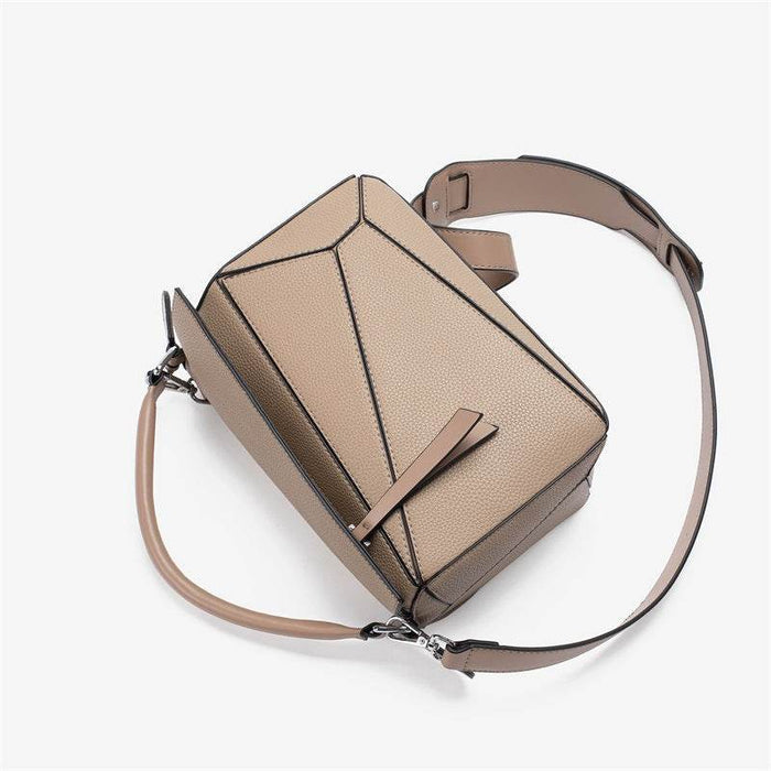 Beige handbag with geometric design on a white background
