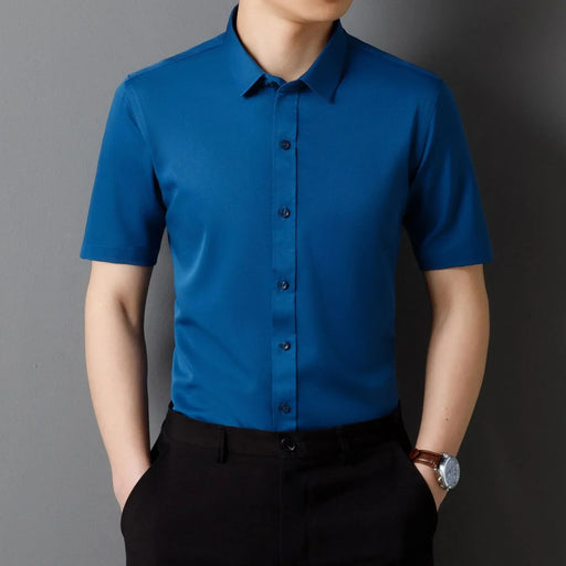 Person wearing a blue short-sleeve shirt against a gray background