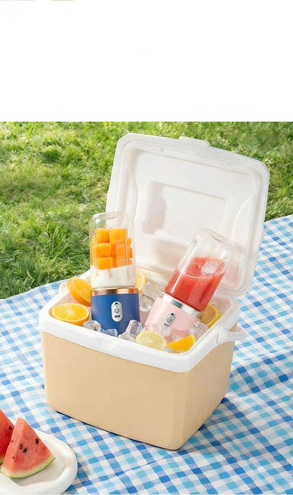 Portable juice maker with fruits on a checkered tablecloth outdoors