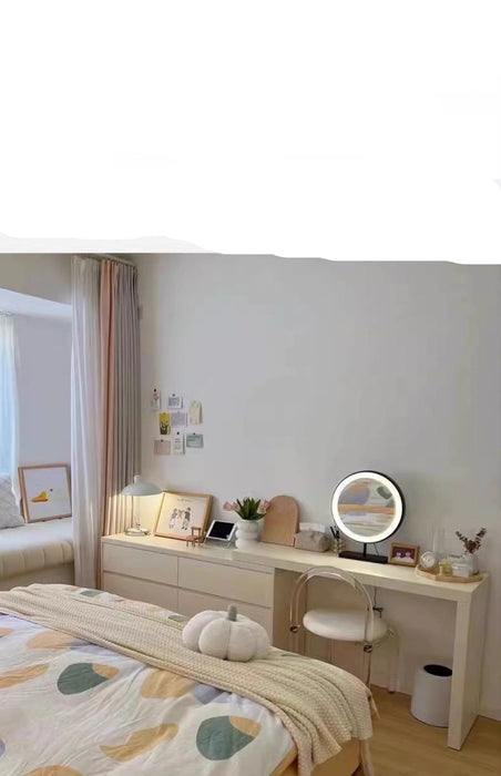 Modern bedroom with a vanity table and mirror, featuring a cozy and organized interior.