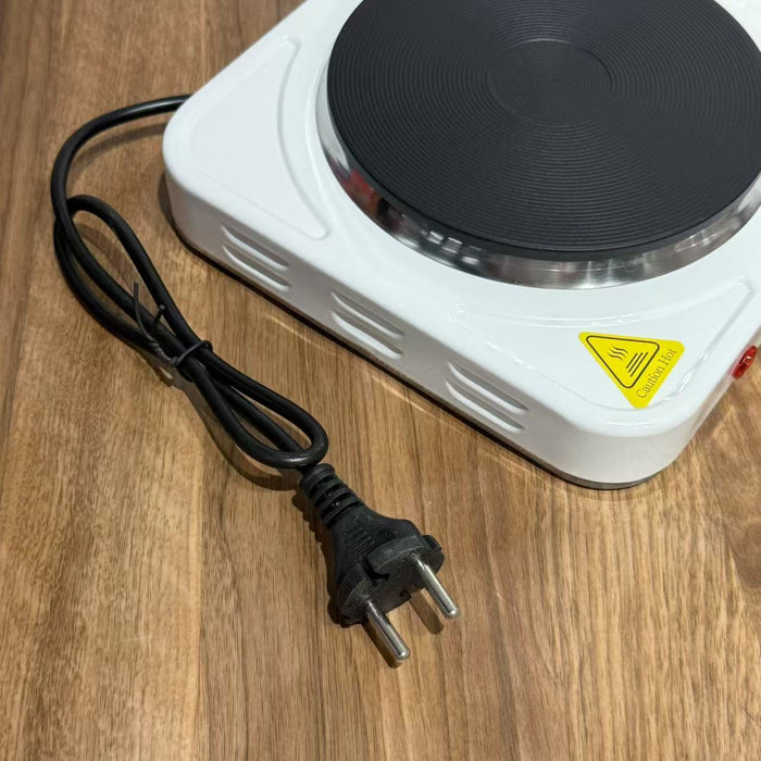 Small electric hot plate with a power cord on a wooden surface