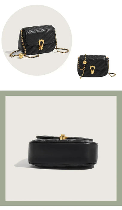 Black handbag with gold accents on a light gray background