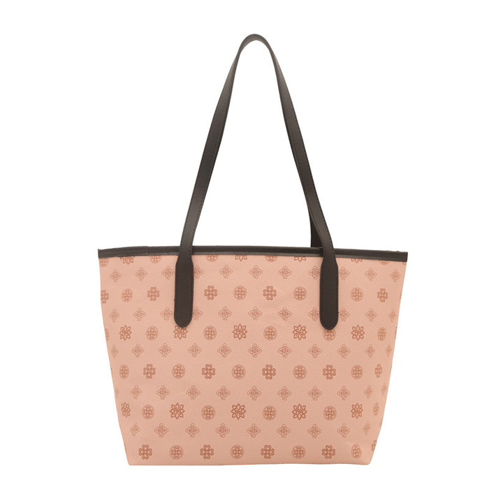 A structured tote bag in a light peach-pink color with an all-over brown monogram pattern, featuring dark brown shoulder straps and trim, shown against a plain white background.
