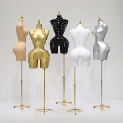 Set of mannequin torso forms on stands in various colors against a white background