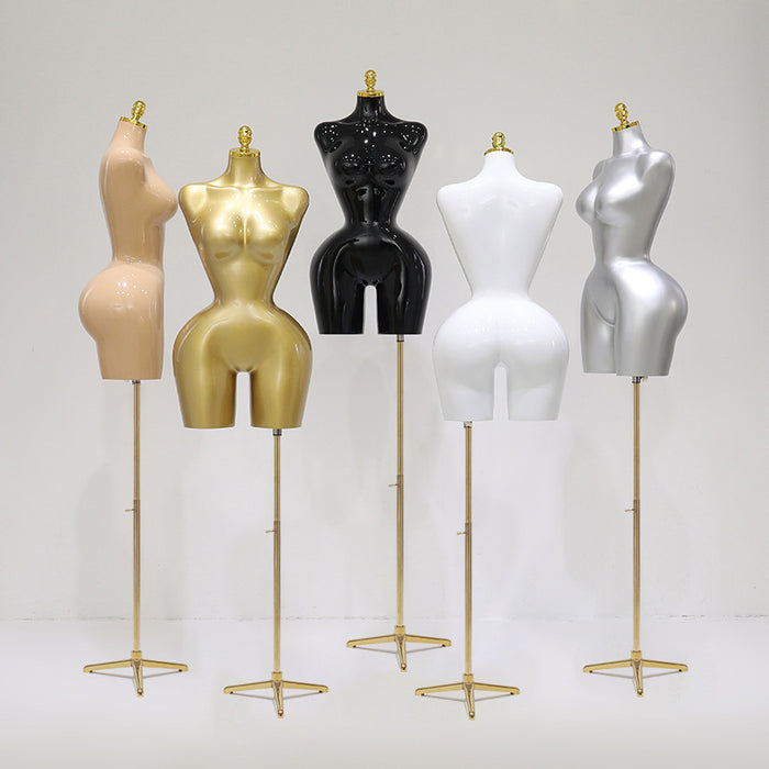 Set of mannequin torso forms on stands in various colors against a white background