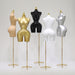 Set of mannequin torso forms on stands in various colors against a white background