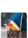Person holding a portable juice container with a brown leather bag in the background
