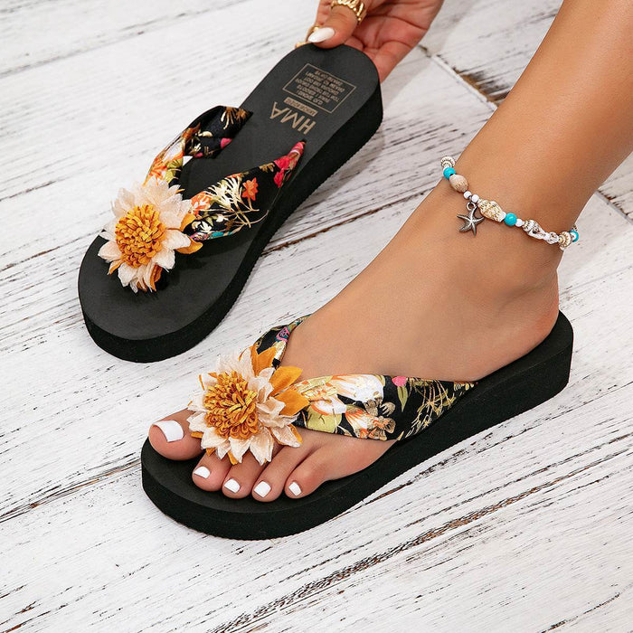 Black floral sandals with a white background