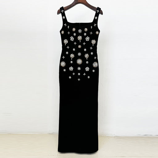 Black dress with floral embellishments on a wooden hanger against a white background
