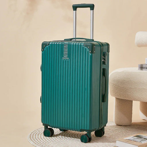 Green suitcase on wheels with a handle, placed on a beige surface.