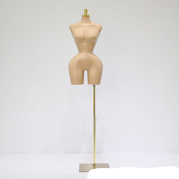 Mannequin torso on a stand against a white background