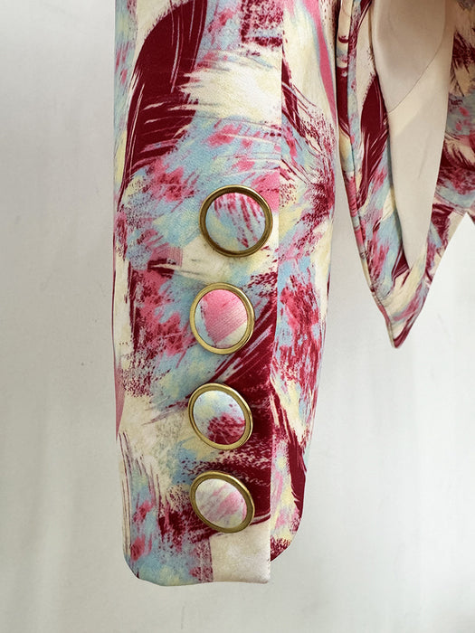 Colorful jacket with abstract design and gold buttons on a white background