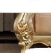 Decorative gold leg of a piece of furniture with text on a white background
