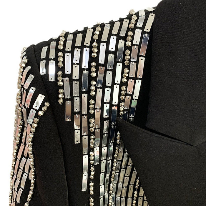 Black garment with silver embellishments on a white background