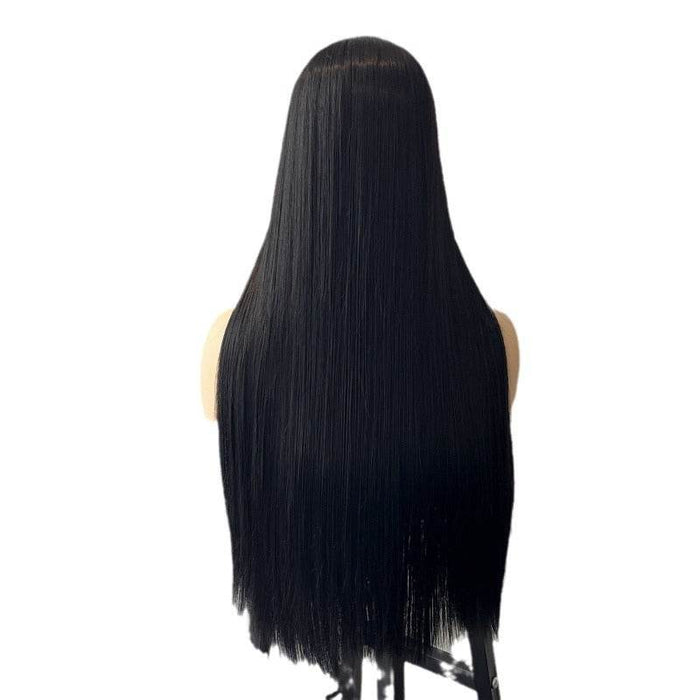 Black wig on a mannequin head against a white background