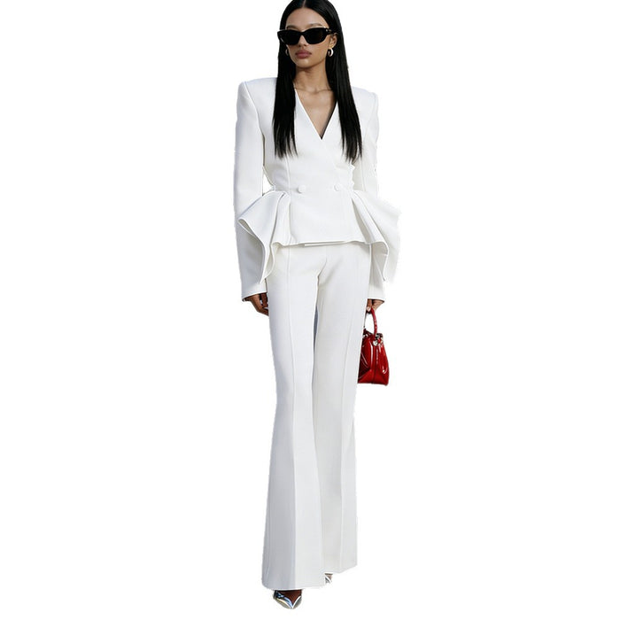 Woman wearing a white suit with a red handbag on a white background