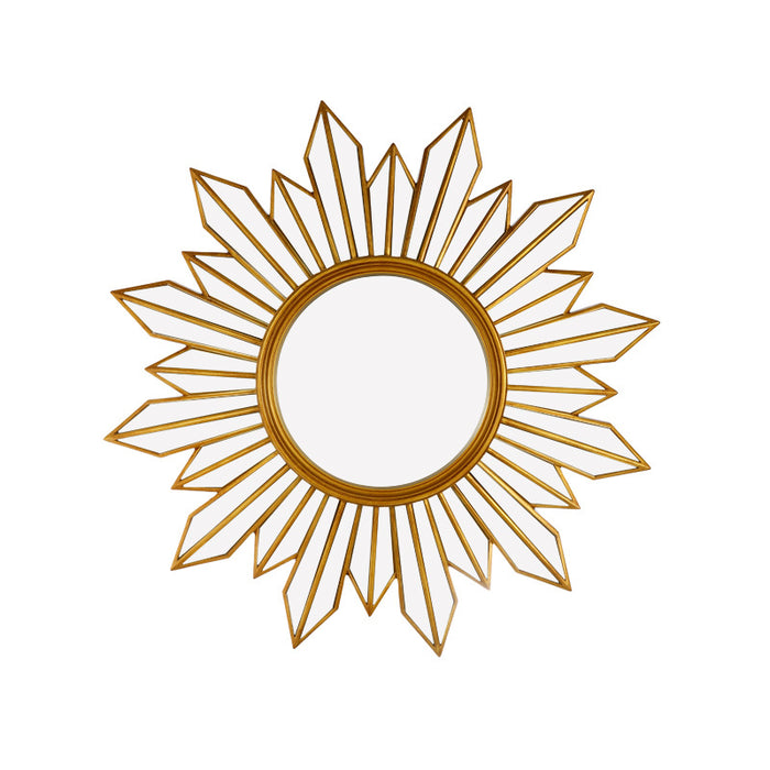 Decorative gold sunburst mirror on a white background