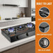 Gas stove on a kitchen counter with features highlighted on an orange panel.