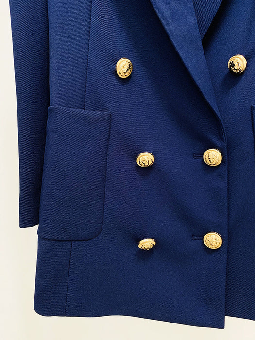 Close-up of a blue blazer with gold buttons on a light beige background