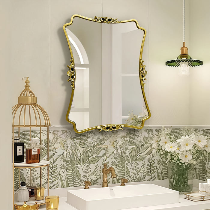 Bathroom with gold-framed mirror, floral wallpaper, and decorative elements.