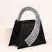 Black handbag with a decorative silver handle on a white background