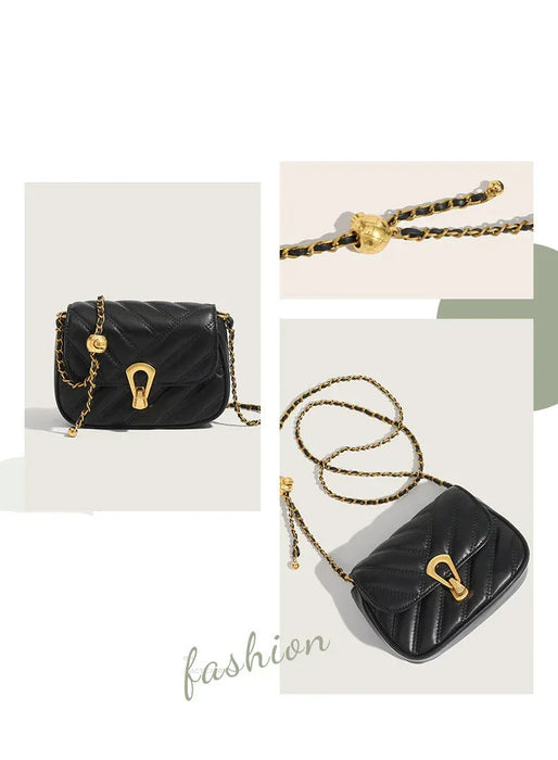 Black handbag with gold chain and clasp on a light background