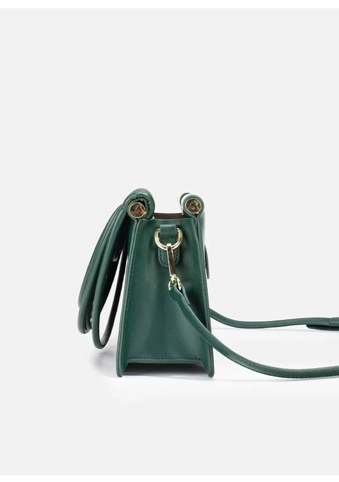 Green handbag with a strap on a white background