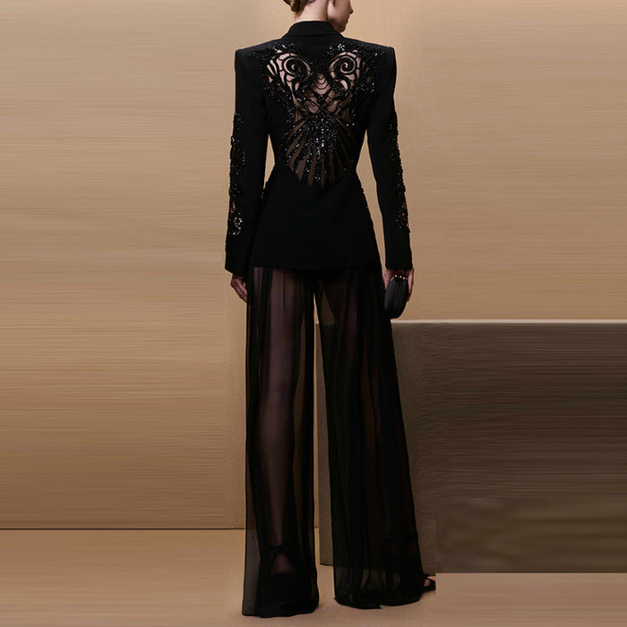 Black outfit with intricate back design on a beige background