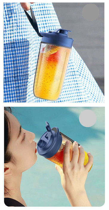 Person holding a colorful drink in a blue lid cup with a blurred background