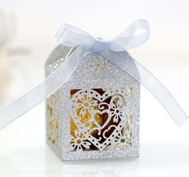 Decorative gift box with a white ribbon on a blurred background