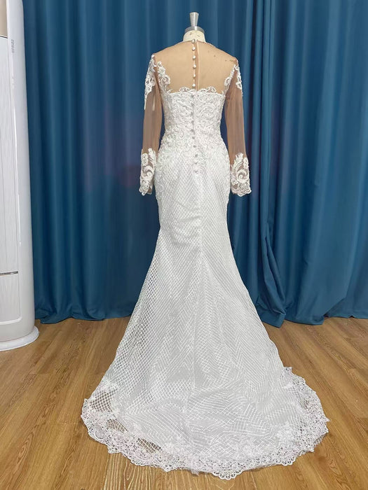White lace wedding dress on a mannequin against a blue curtain background