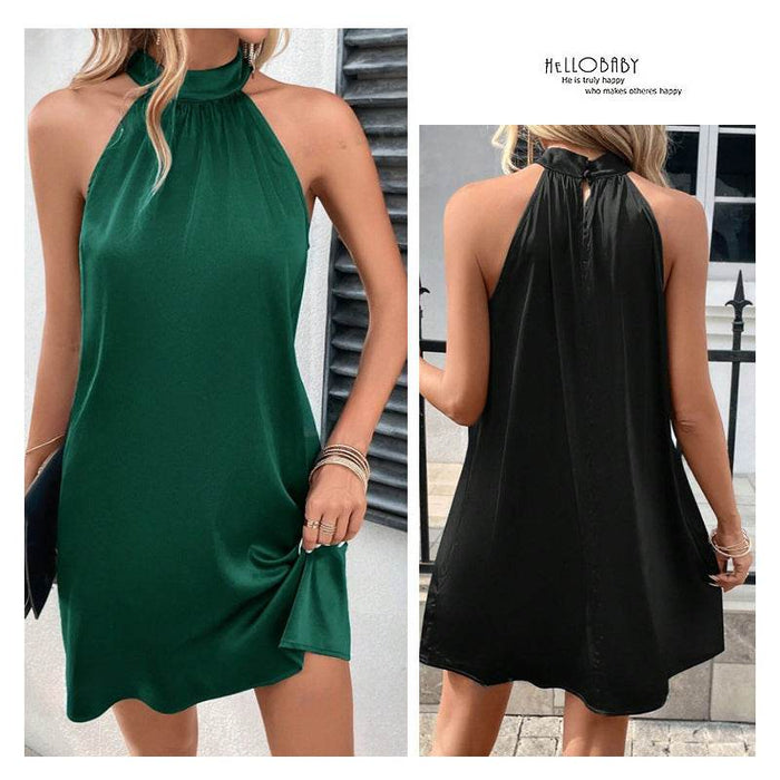 Green and black sleeveless dresses worn by a model outdoors.