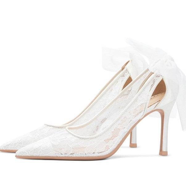 White lace high-heeled shoes on a white background