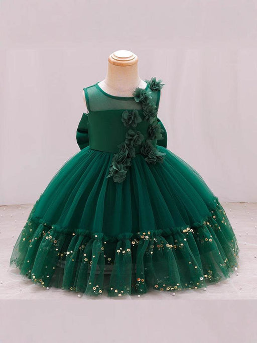 Green dress with floral details on a mannequin against a white background
